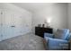 Comfortable bedroom with a cozy chair, dresser, and ample closet space at 5680 Clear Creek Ln, Charlotte, NC 28215