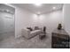 Cozy bonus room features plush carpeting, comfortable seating, and contemporary decor at 5680 Clear Creek Ln, Charlotte, NC 28215