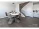 Bright dining area features modern flooring, staircase, and a stylish round table with seating for six at 5680 Clear Creek Ln, Charlotte, NC 28215