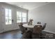 Cozy dining area with a round table, wicker chairs, and natural light streaming through the windows at 5680 Clear Creek Ln, Charlotte, NC 28215