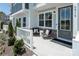 Inviting front porch with seating area, decorative pillows, and a view of the landscaped front yard at 5680 Clear Creek Ln, Charlotte, NC 28215