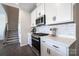 White kitchen featuring stainless steel appliances, minimalist hardware, and subway tile backsplash at 5680 Clear Creek Ln, Charlotte, NC 28215