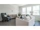 Inviting living room boasts natural light, neutral tones, plush seating, and elegant decor accents at 5680 Clear Creek Ln, Charlotte, NC 28215