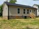 View of the home's backyard showcasing a well-maintained lawn, siding, and wooden deck at 702 Park Ave, Salisbury, NC 28144