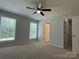 Bright bedroom with two large windows, neutral carpet, ceiling fan and access to the closet at 702 Park Ave, Salisbury, NC 28144