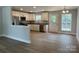 Bright and open kitchen featuring stainless steel appliances, white cabinets, and a wood floor at 702 Park Ave, Salisbury, NC 28144