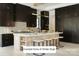 Modern kitchen showcasing dark cabinetry, a large island with seating, and premium marble countertops at Lot 7 Hamlin Rd # 7, Fort Mill, SC 29715