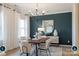 Elegant dining room showcasing stylish decor, a wooden table, and tasteful accents against a blue accent wall at 14042 Aikenwood Dr, Charlotte, NC 28278