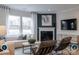 Bright living room boasts large windows, a fireplace, and stylish contemporary furnishings at 14042 Aikenwood Dr, Charlotte, NC 28278