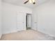 Spacious bedroom with carpet, double door closets, and access to a bathroom at 1535 Solitude Ct, Kannapolis, NC 28081