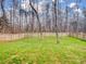 Landscaped backyard with wooden privacy fence at 17628 Cambridge Grove Dr, Huntersville, NC 28078