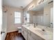 Main bathroom with double vanity and shower/tub combo at 17628 Cambridge Grove Dr, Huntersville, NC 28078