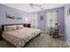 Spacious bedroom with king-size bed and rocking chair at 17628 Cambridge Grove Dr, Huntersville, NC 28078