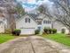 Two-story house with white siding, a two-car garage, and a well-manicured lawn at 17628 Cambridge Grove Dr, Huntersville, NC 28078