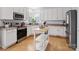 Bright kitchen with white cabinets, stainless steel appliances, and island at 17628 Cambridge Grove Dr, Huntersville, NC 28078