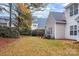 Landscaped backyard with autumn leaves and trees at 2022 University Heights Ln, Charlotte, NC 28213