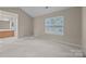 Bright bedroom with neutral walls and carpeted floors at 2022 University Heights Ln, Charlotte, NC 28213