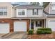 Brick front townhouse with attached garage and landscaping at 2022 University Heights Ln, Charlotte, NC 28213