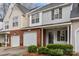 Two-story townhouse with brick, attached garage, and landscaping at 2022 University Heights Ln, Charlotte, NC 28213