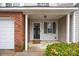 Front entry with brick and siding, a door, and small shrubs at 2022 University Heights Ln, Charlotte, NC 28213