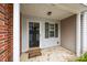 Front entry with brick and siding, a door, and small shrubs at 2022 University Heights Ln, Charlotte, NC 28213