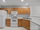 Modern kitchen with white appliances and oak cabinets at 2022 University Heights Ln, Charlotte, NC 28213