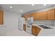 Efficient kitchen with white appliances and light oak cabinets at 2022 University Heights Ln, Charlotte, NC 28213