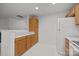 White appliances and oak cabinets in this galley kitchen at 2022 University Heights Ln, Charlotte, NC 28213