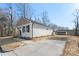 Side view showcases the home's exterior and a large paved driveway at 25 Kesler St, Salisbury, NC 28144