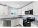 Modern kitchen with stainless steel appliances and granite countertops at 25 Kesler St, Salisbury, NC 28144