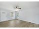 Spacious living room featuring light gray walls, wood-look floors, and a ceiling fan at 25 Kesler St, Salisbury, NC 28144