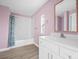 Stylish bathroom with a white vanity, framed mirror, and tub with marble-look tiling and stylish curtain at 3433 Spinner Ct, Sherrills Ford, NC 28673