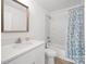 Bright bathroom featuring a white vanity, framed mirror, and tub with marble-look tiling and stylish curtain at 3433 Spinner Ct, Sherrills Ford, NC 28673