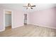 Bedroom featuring pale pink walls, wood-look flooring, and an open doorway to an ensuite bathroom at 3433 Spinner Ct, Sherrills Ford, NC 28673