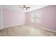 Light-filled bedroom with a ceiling fan, wood-look floors, and two windows providing natural light at 3433 Spinner Ct, Sherrills Ford, NC 28673