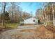 Exterior view of home featuring a side entrance, screened-in porch, and graveled yard at 3433 Spinner Ct, Sherrills Ford, NC 28673