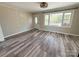 Bright living room with neutral walls, wood-look floors, and large windows at 3654 Lynwood Dr, Lancaster, SC 29720