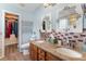 A bathroom with double sinks, granite countertops, and decorative mirrors at 4008 Saphire Ln, Indian Trail, NC 28079