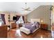 A main bedroom with a ceiling fan, wood floors, and contemporary furnishings at 4008 Saphire Ln, Indian Trail, NC 28079