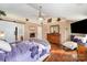 A bedroom featuring wood floors, a ceiling fan, and a view of the en suite bathroom at 4008 Saphire Ln, Indian Trail, NC 28079