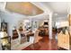 An open-concept dining area with a wooden table, chairs, and view of the living room, showcasing modern design elements at 4008 Saphire Ln, Indian Trail, NC 28079