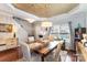 A dining room with a wooden table, four chairs, a modern light fixture, and stylish wallpaper at 4008 Saphire Ln, Indian Trail, NC 28079