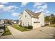 View of home featuring attached garage, manicured landscaping, and ample parking at 4008 Saphire Ln, Indian Trail, NC 28079