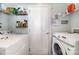 A laundry room with a washer and dryer, shelving, and ample storage space at 4008 Saphire Ln, Indian Trail, NC 28079