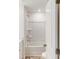 A clean bathroom features a shower-tub combo with white tiles and vanity with white countertops at 4031 Lawnview Dr, Charlotte, NC 28269