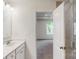 A bathroom has tile flooring, a single sink vanity, and a glass enclosed shower at 4031 Lawnview Dr, Charlotte, NC 28269