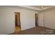 Bedroom featuring neutral carpet, a decorative ceiling, and multiple doorways and openings at 4031 Lawnview Dr, Charlotte, NC 28269