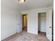 Bedroom featuring neutral carpet, white walls, open closet and doorway to a room painted yellow at 4031 Lawnview Dr, Charlotte, NC 28269