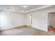 Bedroom with white walls, carpet, and tray ceiling with a doorway that leads to another room in the house at 4031 Lawnview Dr, Charlotte, NC 28269