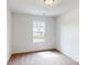 A bright bedroom features neutral carpet, white walls, and a window offering a view of the home's exterior at 4031 Lawnview Dr, Charlotte, NC 28269